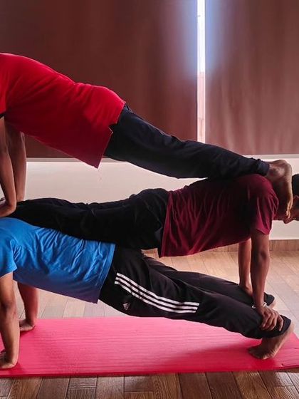 This is the same group as image 124, holding a strong three-person plank. It takes teamwork and a lot of core strength from everyone involved.