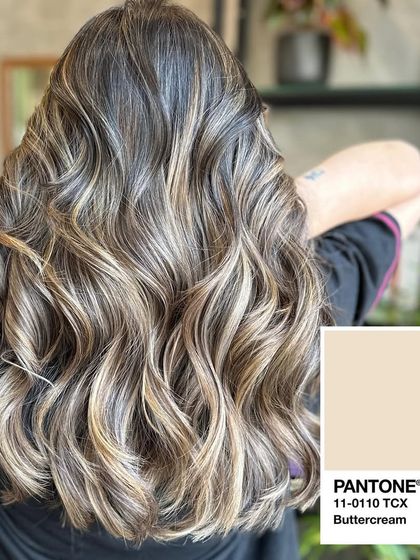 Inspired by the Pantone color Buttercream, this balayage features soft, creamy blonde highlights for a delicate and pretty look.