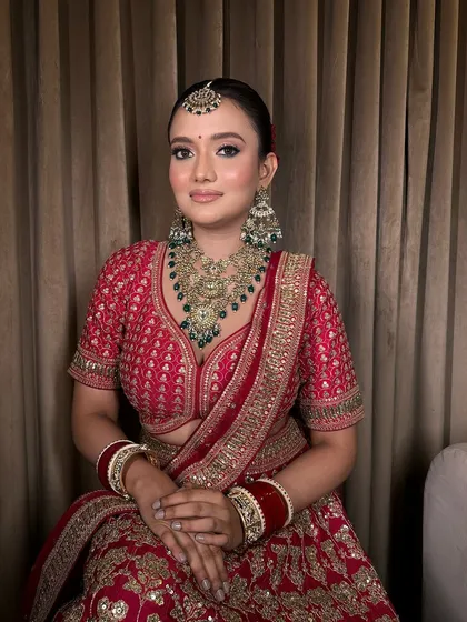 This bride's complete look is a testament to the power of classic bridal beauty. The red lehenga and traditional jewellery are a match made in heaven.
