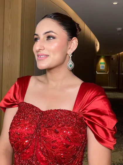 The side profile of this bridesmaid in her stunning red gown. The clean makeup and sleek hair ensure that she looks sophisticated and beautiful.