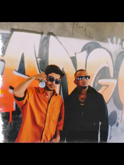 Posing with rapper Sambata in front of the graffiti I painted for his music video. The art became a key part of the track's visual identity.