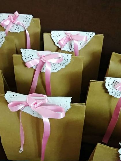 A full view of the beautifully packaged return gift bags. Each one is a little bundle of joy, ready to be handed out at a pre-wedding function.