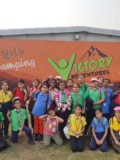 Students gather in front of the "Victory Adventures" banner, excited for a day of camping activities. We partner with professional organizations to ensure a safe and well-organized experience.