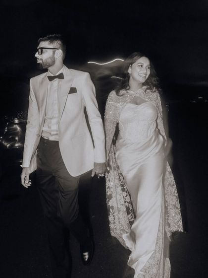A stylish black and white portrait of the couple walking at night, capturing a cool, cinematic vibe.