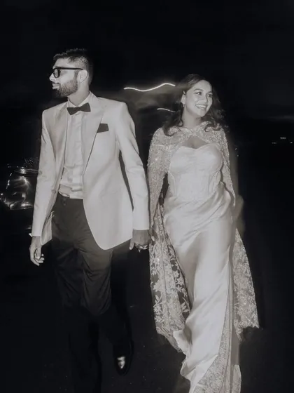 A stylish black and white portrait of the couple walking at night, capturing a cool, cinematic vibe.