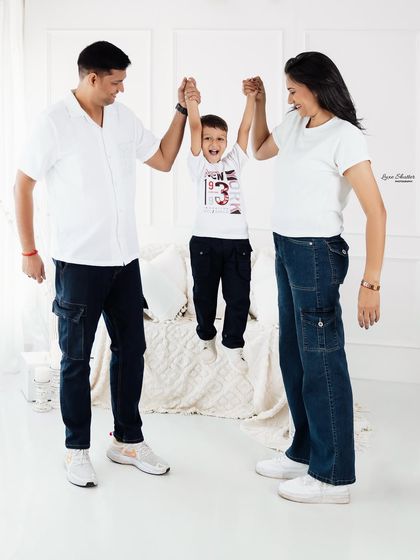 Up you go! A joyful moment as parents swing their son. Our family sessions are about creating happy memories, not just taking pictures.