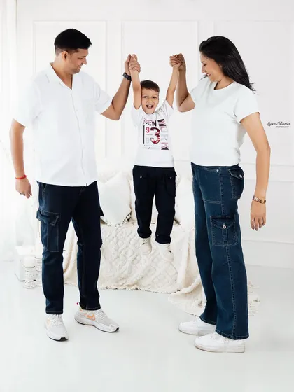 Up you go! A joyful moment as parents swing their son. Our family sessions are about creating happy memories, not just taking pictures.