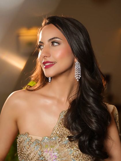 A smiling portrait of the model, her diamond earrings adding a touch of sparkle.