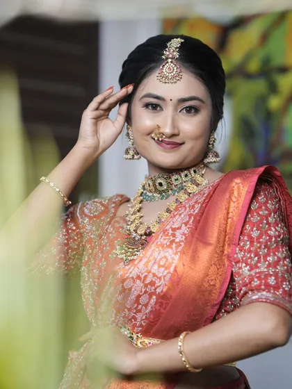 A closer look at the bridal makeup, showing the detailed eye work, traditional bindi, and how the HD foundation creates a smooth finish. I ensure every detail, from the maang tikka placement to the nose ring, is perfect for your big day.
