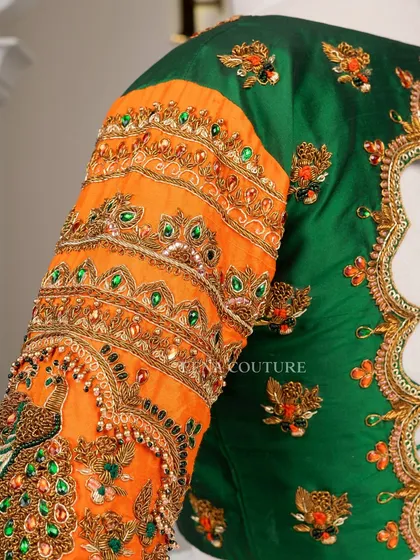 This blouse is a celebration of vibrant color and artistry. I used a rich green raw silk base and contrasted it with bright orange sleeves, which feature incredibly detailed peacock embroidery using zardozi, stones, and beadwork.