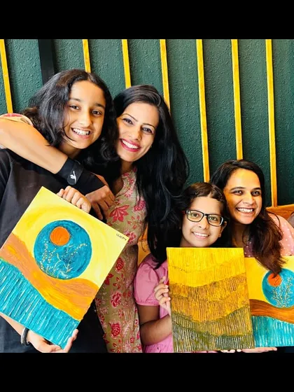 A group of happy artists with their unique Wabi Sabi textured paintings. Each piece reflects their personal journey of embracing imperfection.