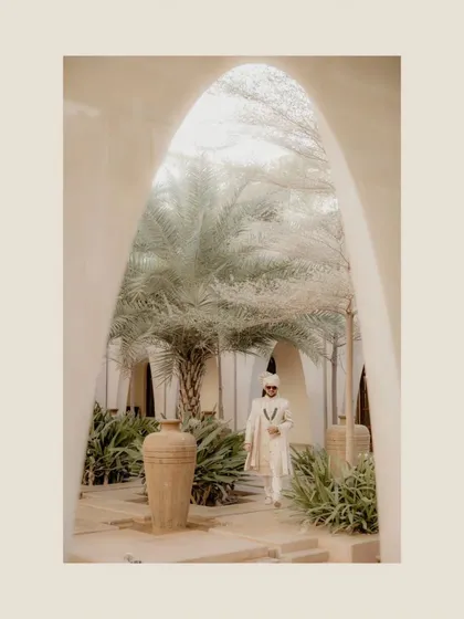A duplicate of the groom's grand entrance, emphasizing the stunning architecture and his regal presence.