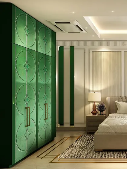 A bold and classy bedroom featuring striking emerald green wardrobes with geometric patterns and brass handles, creating a powerful design statement.