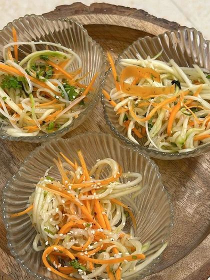 Small bowls of refreshing raw papaya and carrot salad, a healthy addition to my lunch thalis.