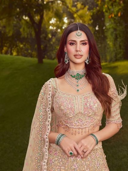 A full-length portrait of this modern bridal look. The makeup is elegant and understated, allowing the intricate Tarun Tahiliani lehenga to shine.