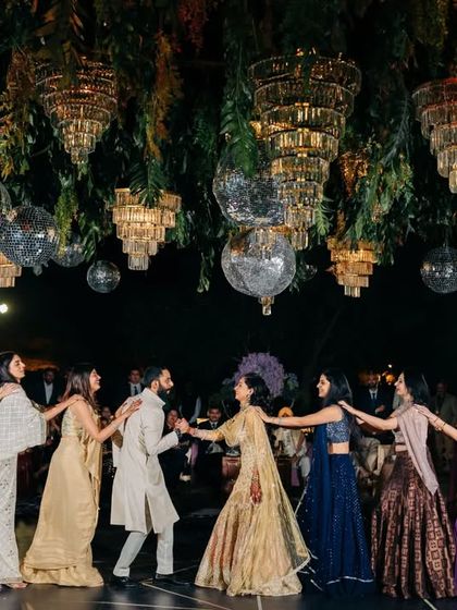 A beautiful final pose with the bride and groom at the center, surrounded by their loved ones. This is the perfect ending to a memorable family performance.