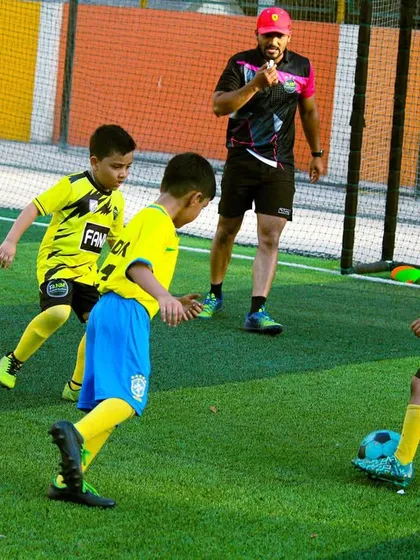 A coach oversees a drill with our youngest players, creating a fun and structured learning environment.