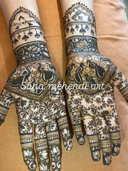 This Sawan festival mehndi is packed with detail, featuring dancing peacocks and a dense floral pattern. I also personalized it by hiding the names 'Anuj' and 'Pooja' in the design, a special touch I love to add.