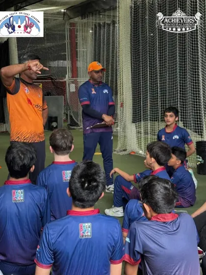 A coach giving instructions to a group of young players during the CYCA trials.
