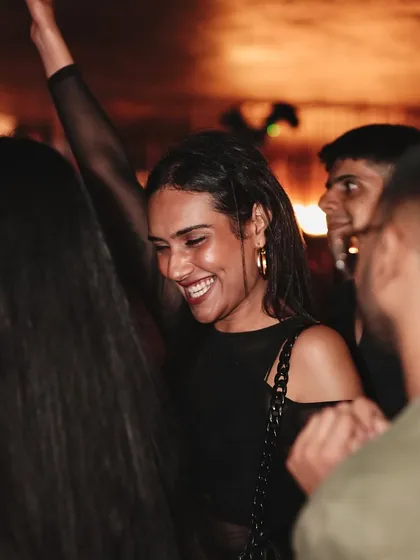 A guest smiling and dancing, embodying the good vibes of the night.