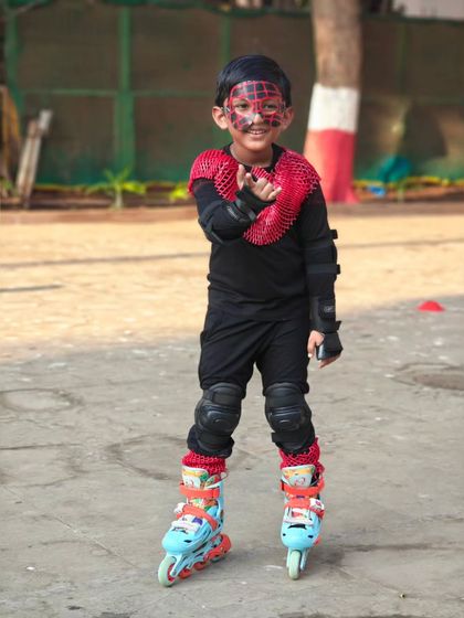 This young skater is ready to roll with cool face paint and a spiderman-inspired costume.