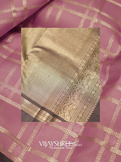 A close-up of a pink Kanjivaram with gold checks and a traditional border, a classic piece from our festive collection.