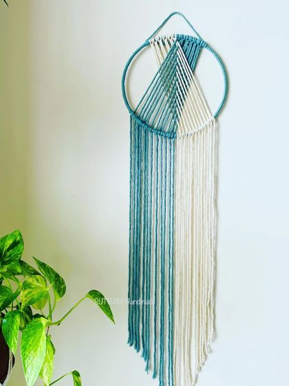 A simple, minimal, and sustainable dreamcatcher with soothing colors. This one combines a soft teal and off-white for a very calming effect. The long fringes give it a beautiful, flowing look.