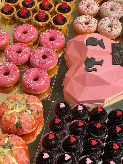 For a fun bachelorette, I created this entire Barbie-themed dessert table. It features a pink geometric smash cake, glazed donuts, and rich chocolate cupcakes, showing how I can bring any party theme to life.