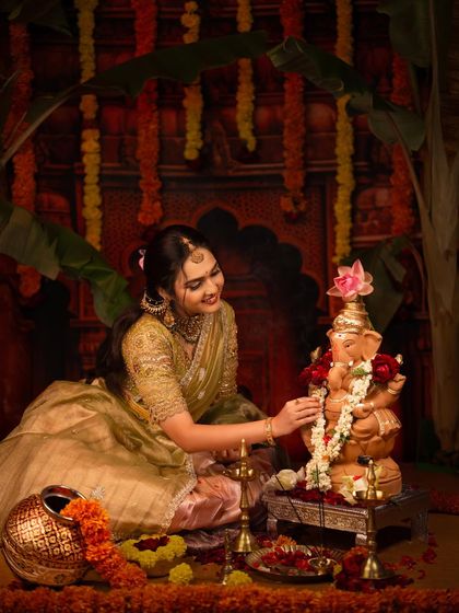 A close-up of the woman decorating the Ganesha idol with a lotus flower, a simple yet meaningful act of worship.