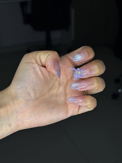 This view shows the subtle shimmer and delicate design of the ombre nail set, a testament to our students' refined skills.