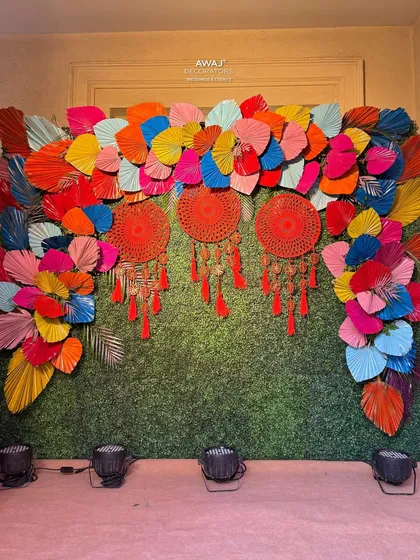 The full view of the paper fan and dreamcatcher photo wall, a perfect spot for fun and memorable pictures.