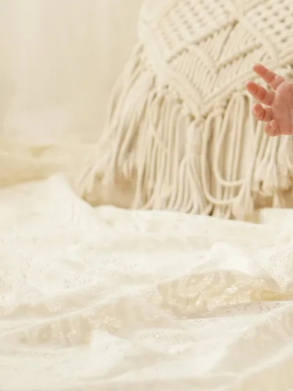 A playful detail shot of a baby's tiny hand reaching out. These candid moments are just as precious as posed portraits and add life and movement to the gallery.