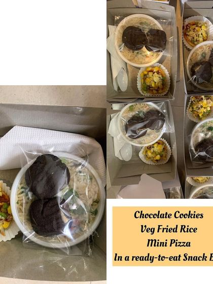 A simple yet satisfying snack box containing veg fried rice, mini pizza, and chocolate cookies. Perfect for school events or casual get-togethers.