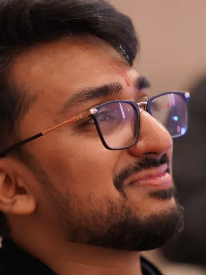 The look of pure emotion. This close-up captures the groom's teary-eyed expression while watching a performance during his engagement, a truly raw and beautiful moment.