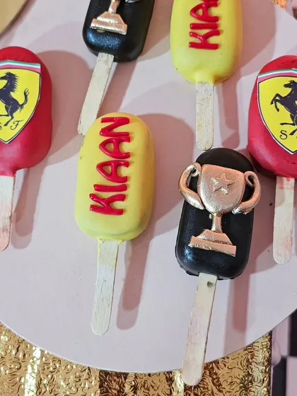 Ferrari-themed cakesicles, personalized with the birthday boy's name and age.