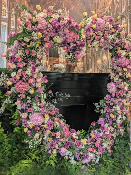 Flowers can celebrate love at any age. I designed this magnificent heart-shaped floral arch for a 60th birthday party, using a romantic palette of pinks and purples to create a stunning photo backdrop and a symbol of joy.