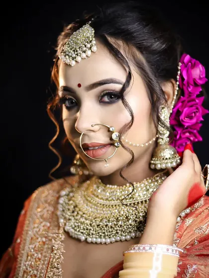 The side profile of this Bengali bride shows off the elegant hair updo adorned with fresh roses. My hair styling module covers a wide range of bridal hairstyles, including working with accessories.