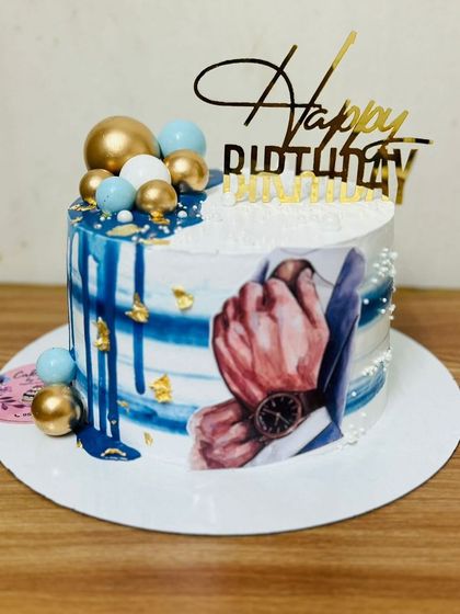 A stylish birthday cake for a man, featuring a suit and watch design.