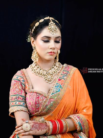 A serene, eyes-closed shot to showcase the beautiful eye makeup. The soft blend of colors on the lid adds a touch of modern artistry to the traditional look.