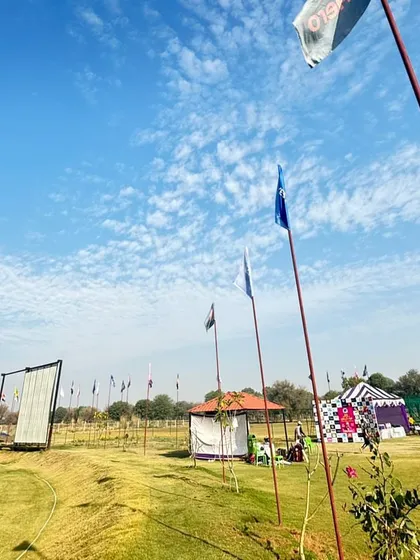 A view of our grounds set up for a tournament. The flags, tents, and sight screens create a professional match-day atmosphere, which we believe is crucial for preparing players for competitive cricket.