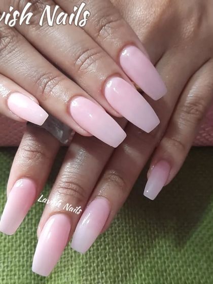 A classic set of long, coffin-shaped nails in a solid, milky pink color.