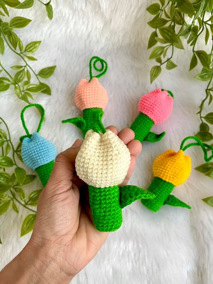 Holding a few of the tulip lipstick holders to show their size and detail. The little curly vine on top is a fun touch.