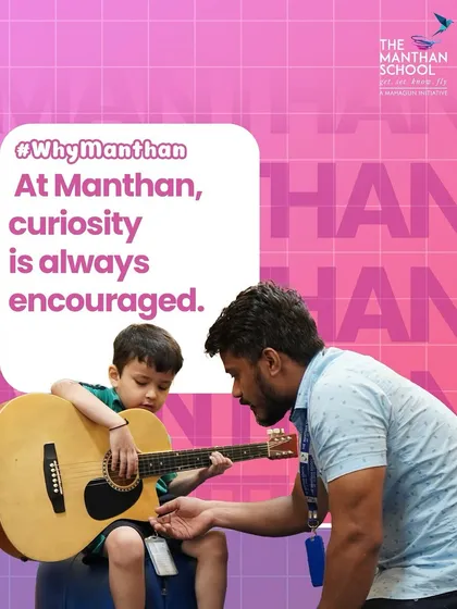 We encourage curiosity in all its forms, including music. A teacher guides a young student as he explores the guitar, nurturing an early appreciation for musical instruments and sound.