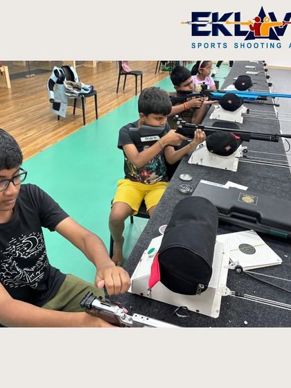 Young shooters at the firing line, learning to load and handle their air rifles. We use professional equipment, including rests for beginners, to help them focus on technique.
