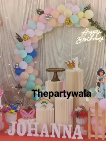 A pastel rainbow princess theme is a beautiful and gentle choice for a first birthday. The soft colors of the balloon arch and the princess cutouts create a dreamy atmosphere.