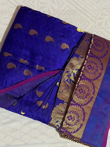 A royal blue Banarasi saree with gold motifs. Pre-pleating helps manage the stiffness of new silk sarees, making them easier to wear.