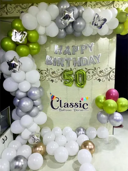 A variation of the 50th birthday home setup, this time using a green, white, and silver color palette. We can customize the colors of our balloon arches to match your preference.