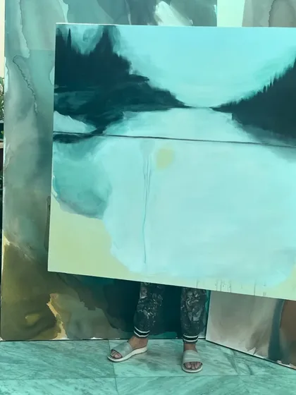 Me holding the 4ft x 4ft canvas, with the larger pieces from the same series in the background.