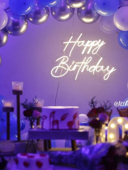 The 'Happy Birthday' neon sign glowing through the purple-lit smoke, creating a cool and mysterious party vibe.