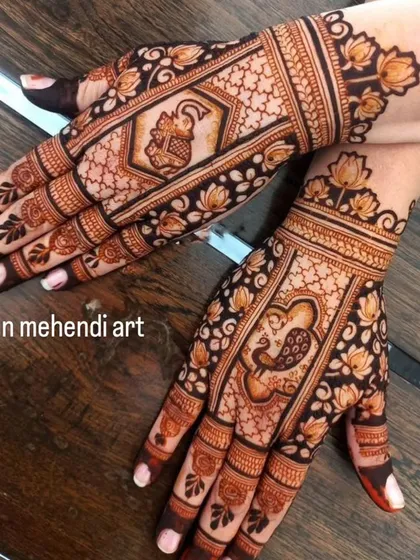 This design features an elephant on one hand and a peacock on the other, both central figures in traditional Indian art. The surrounding lotus patterns add to the beauty.